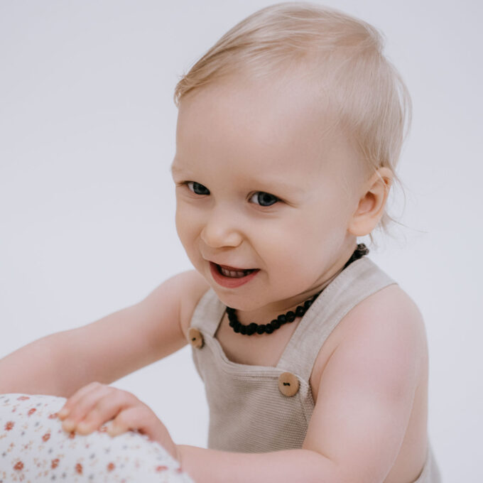 baby with raw black amber necklace for teething